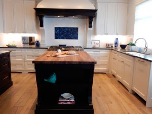 kitchen island with butcherblock counter and black paint